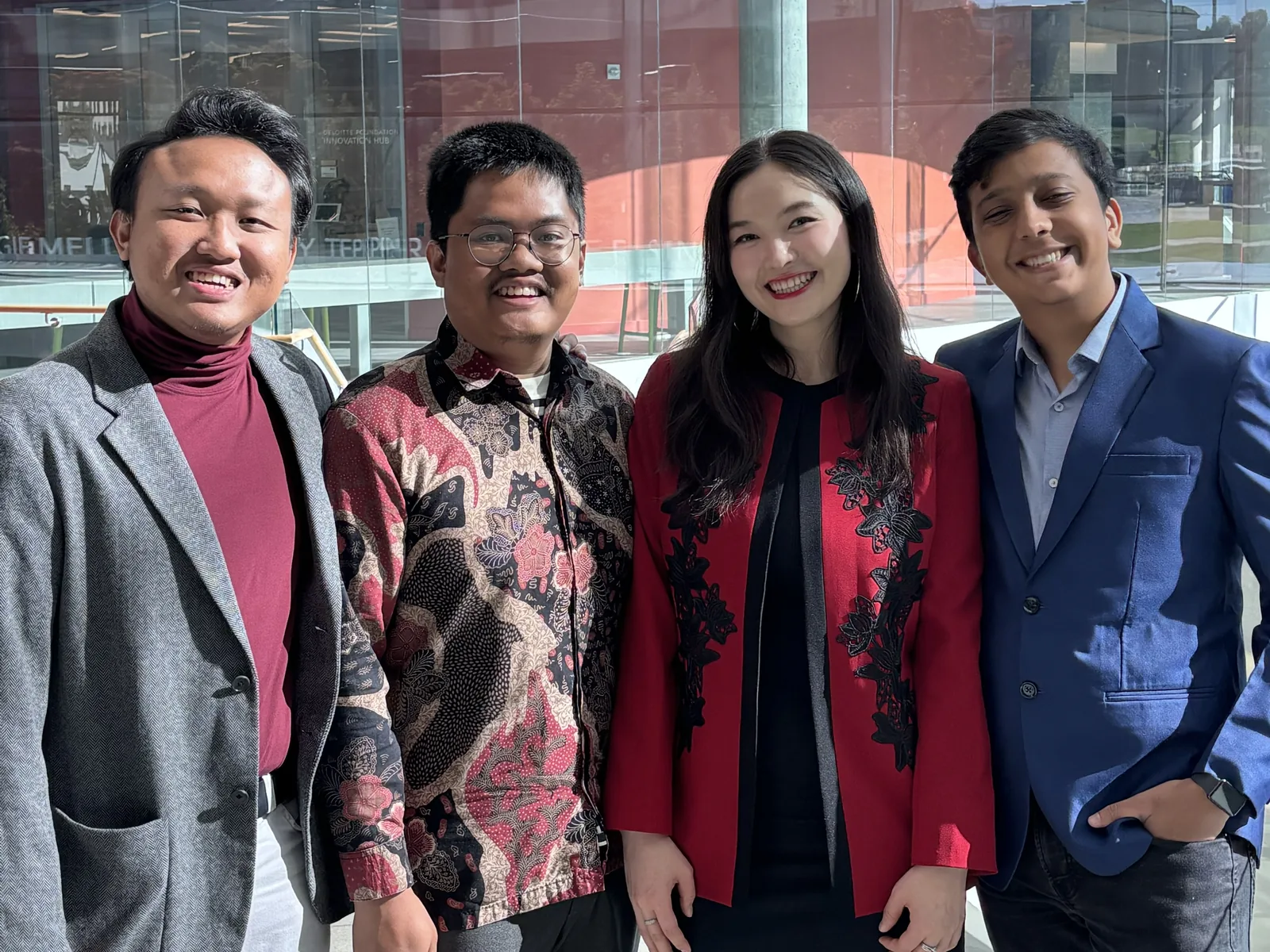 Yusril, Rizaldy, Egshiglen and Meet, smiling, in a glass atrium at Carnegie Mellon.